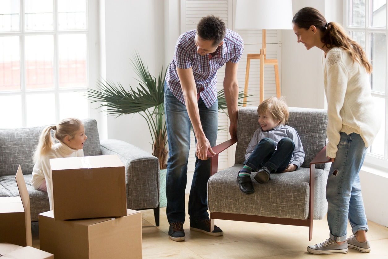 Happy family with kids playing on moving day at home